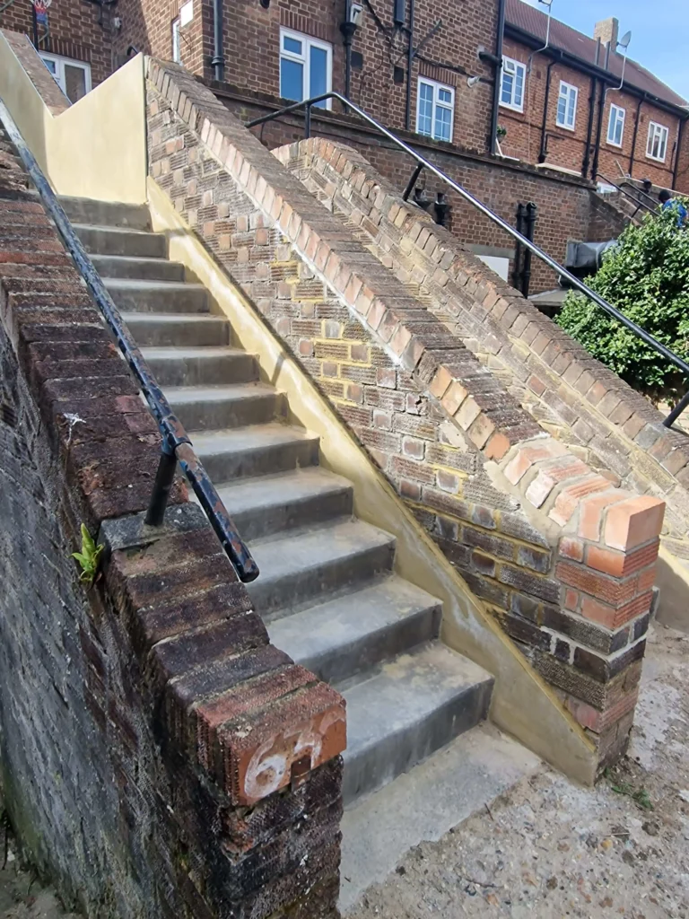 Refurbished brick stair walls before aluminium coping installation