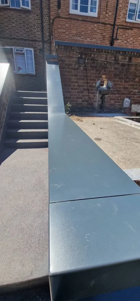 Close-up of aluminium coping installed on brick walls for weather protection